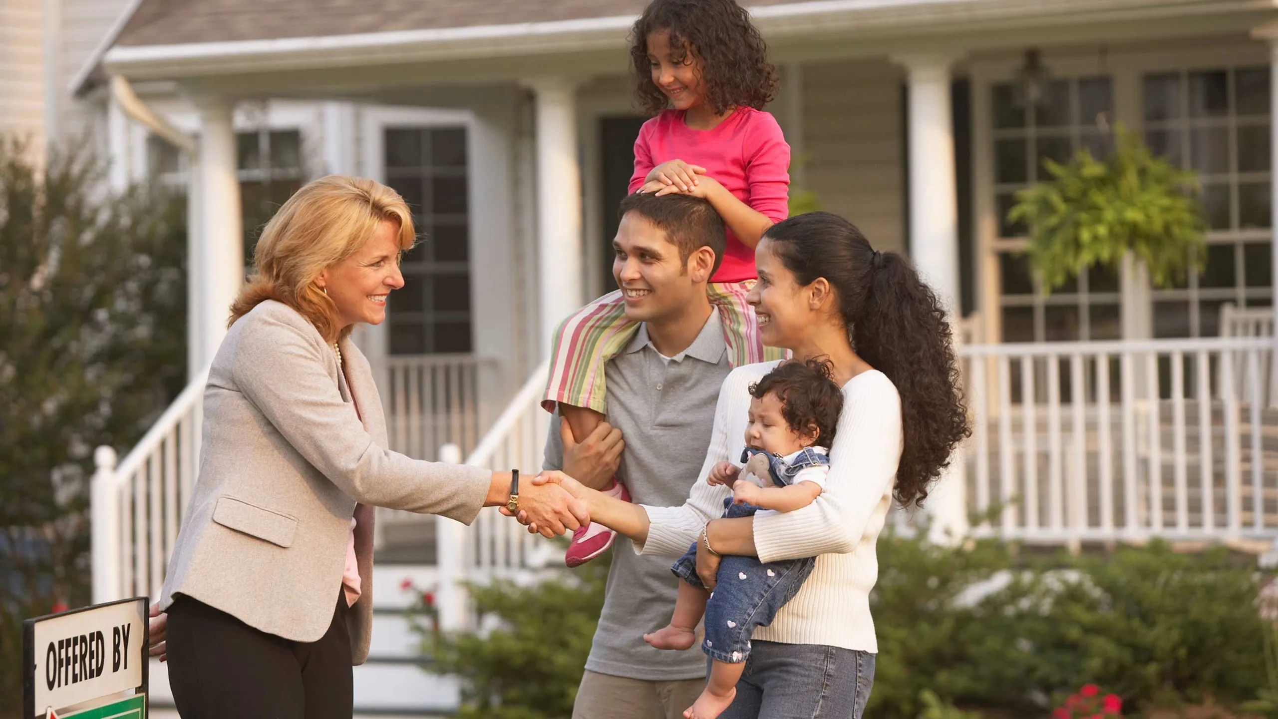 Realtor helping a family explore a home